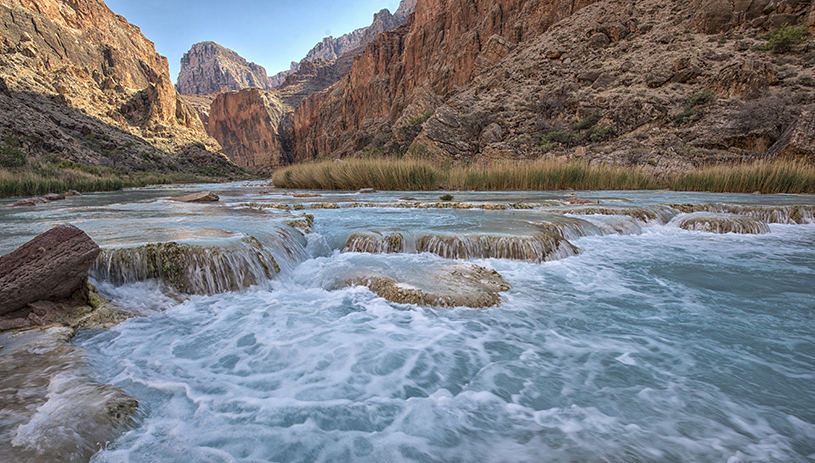 Travertine dams with electric blue warm carbonate water of the little colorado river. ADAM HAYDOCK