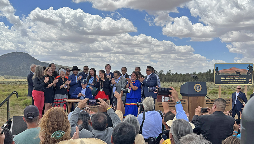 Tribal leaders celebrate the designation of Baaj Nwaavjo I'tah Kukveni national monument with Red Butte in the background. U.S. DEPARTMENT OF THE INTERIOR