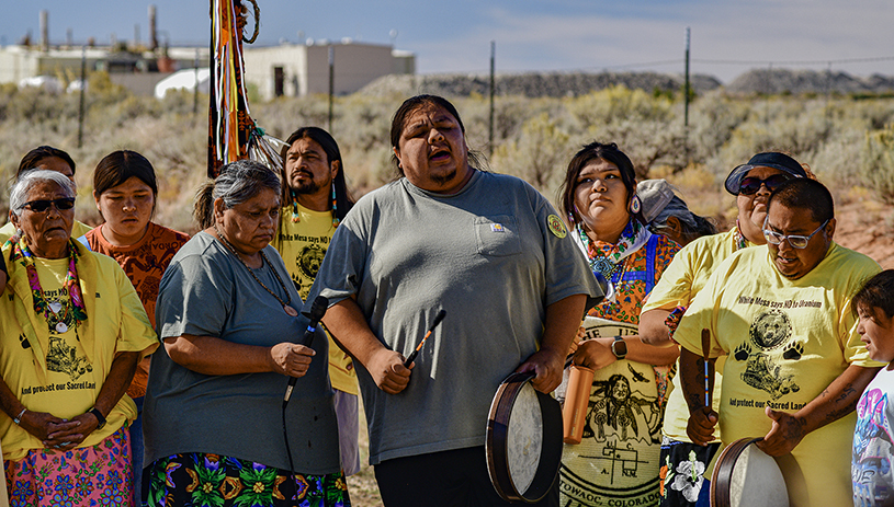 Anferny Cly sings near the mill entrance, at the close of the White Mesa Concerned Community's 2024 Spiritual Walk. TIM PETERSON