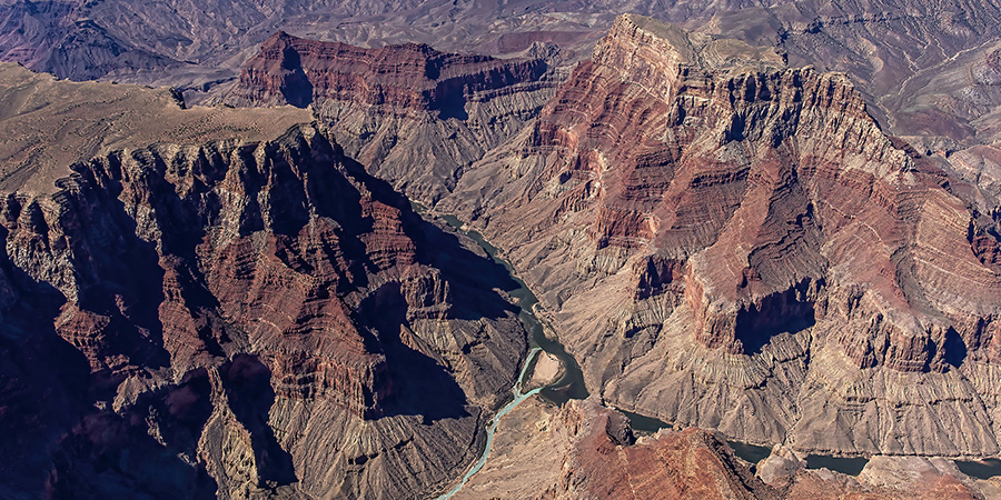 Aerial view of the turquoise Little Colorado River meeting green Colorado River in the Grand Canyon