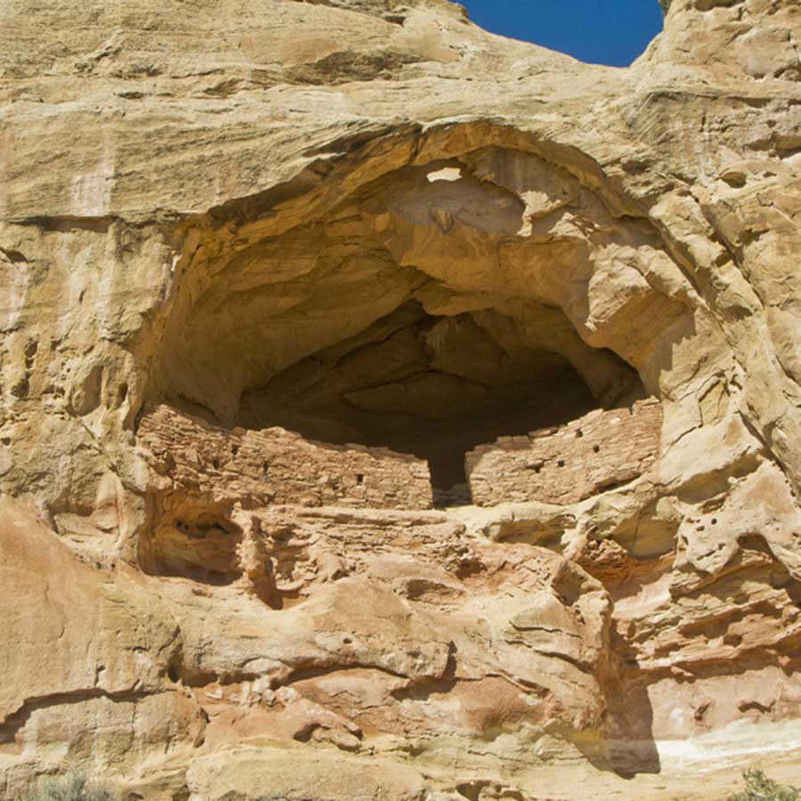 An archaeological structure in an alcove of a sandstone canyon wall