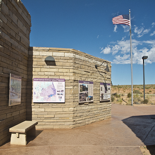 A pale brick building with a flag flying