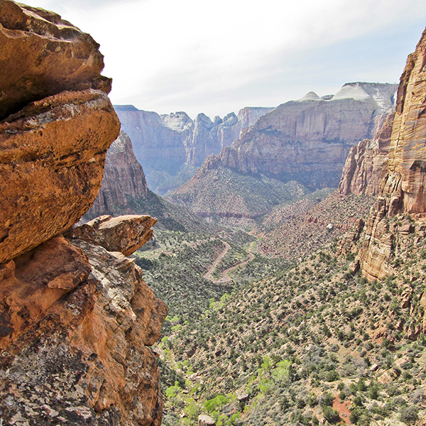 Rocky overlook looking down on green canyon bottom