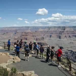 Tourists enjoying views of the Grand Canyon from one of the overlooks on the Rim Trail