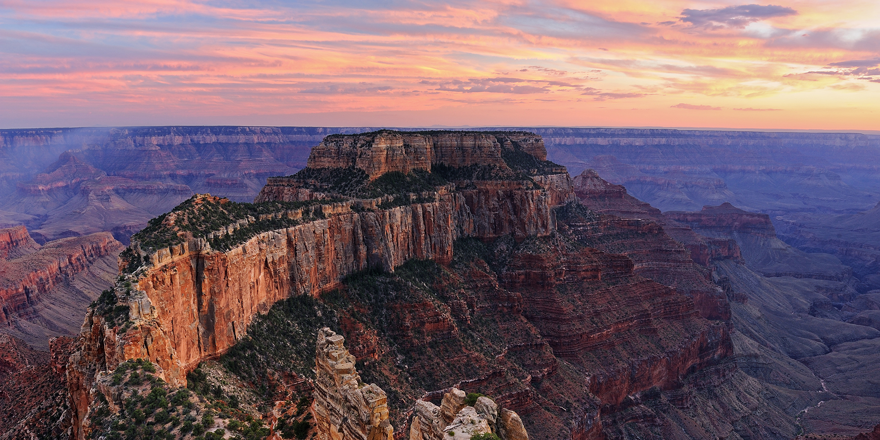 A colorful sunset compliments the spectacular formations of Cape Royal on the Grand Canyon's north rim.