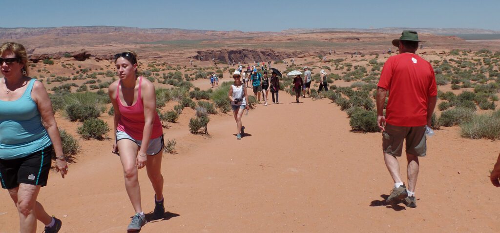 Crowds of people on a sandy trail