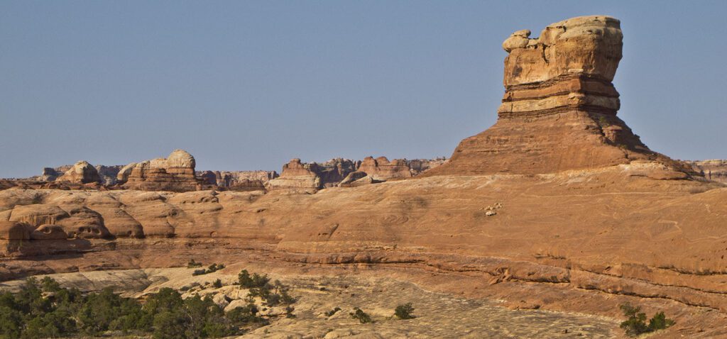 A knob of orange sandstone juts up from a bench.