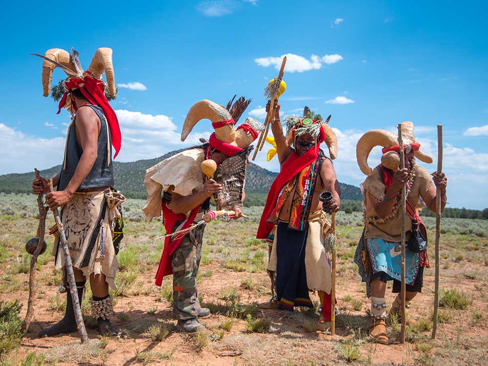 Havasupai dancers in front of Red Butte during an intertribal gathering to protect canyon uranium mine