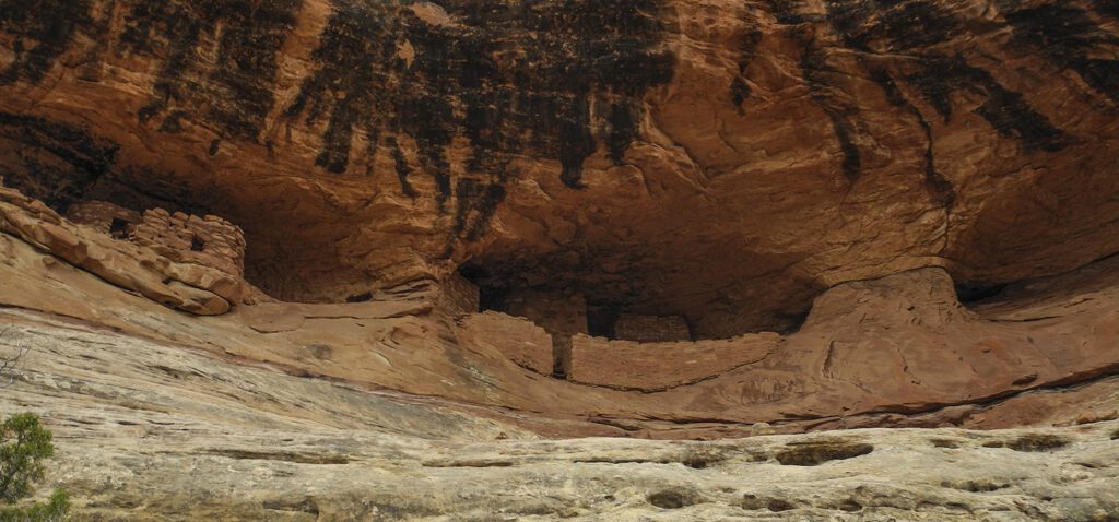 Archaeological structures on a ledge in a sandstone canyon