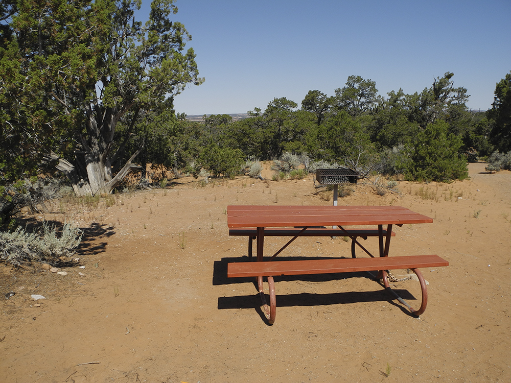 A red picnic table in an empty site at Sunset View Campground