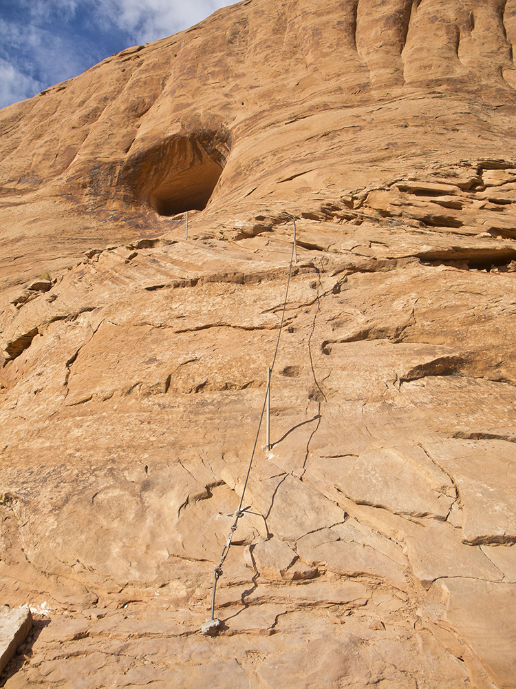 Cables drilled into sandstone on a steep pitch of the trail