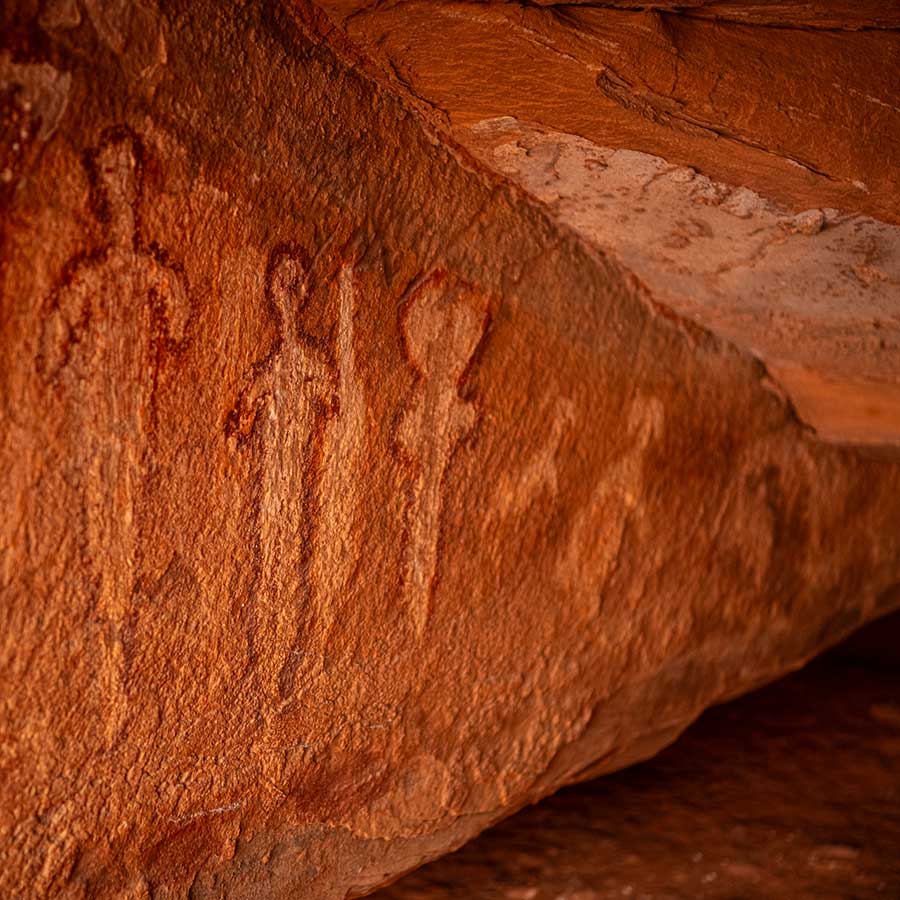 Pictographs of human-appearing figures on orangish red rock in Baaj Nwaavjo I'tah Kukveni National Monument