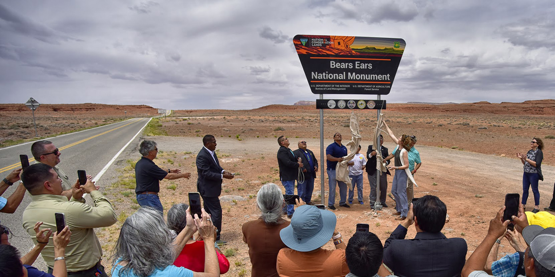 A crowd films on cell phones as a the Bears Ears National Monument sign is unveiled