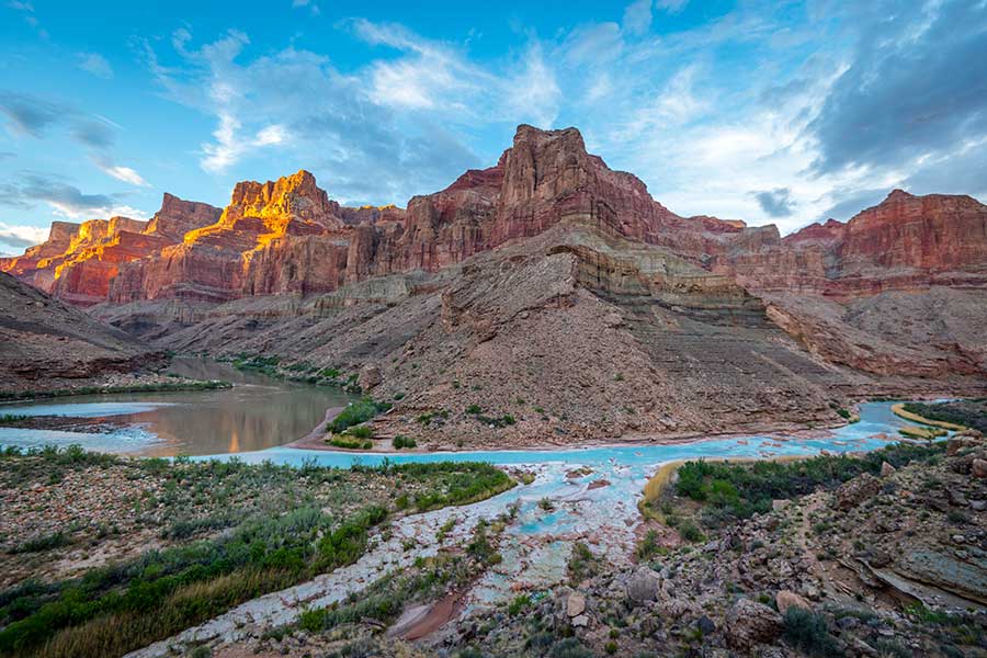 The bright turquoise waters of the Little Colorado River under the cliffs of the Grand Canyon