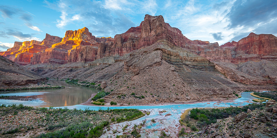 Milky turquoise waters of the Little Colorado River flow into the green-brown mainstem of the Colorado River in the Grand Canyon