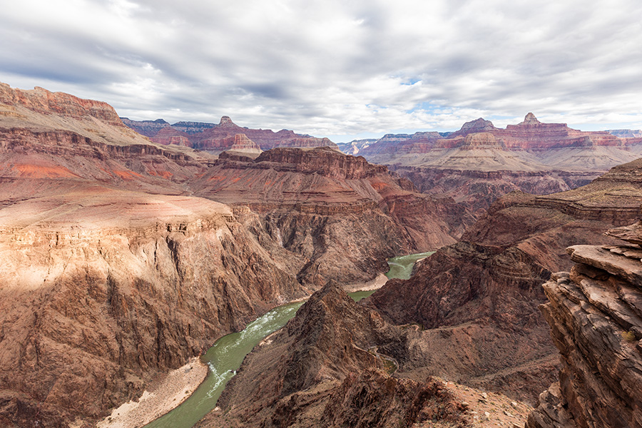 Very green Colorado River runs through red cliffs in the Grand Canyon