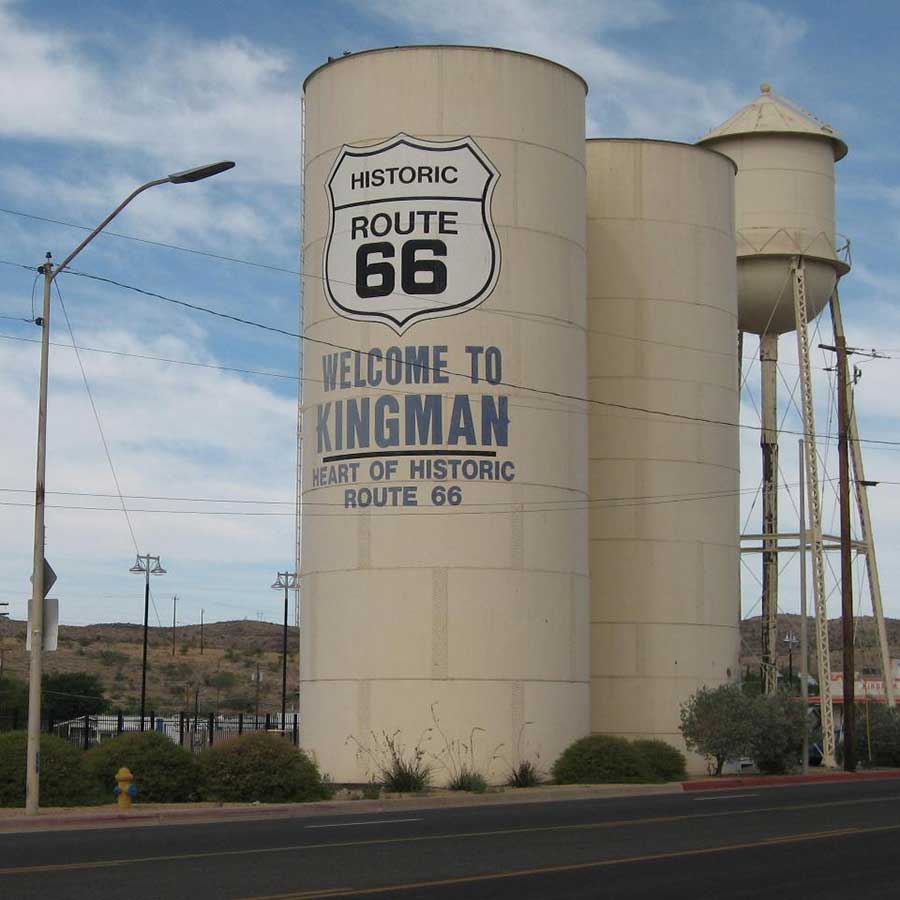 A water tower in Kingman, Arizona with a Route 66 sign painted on it