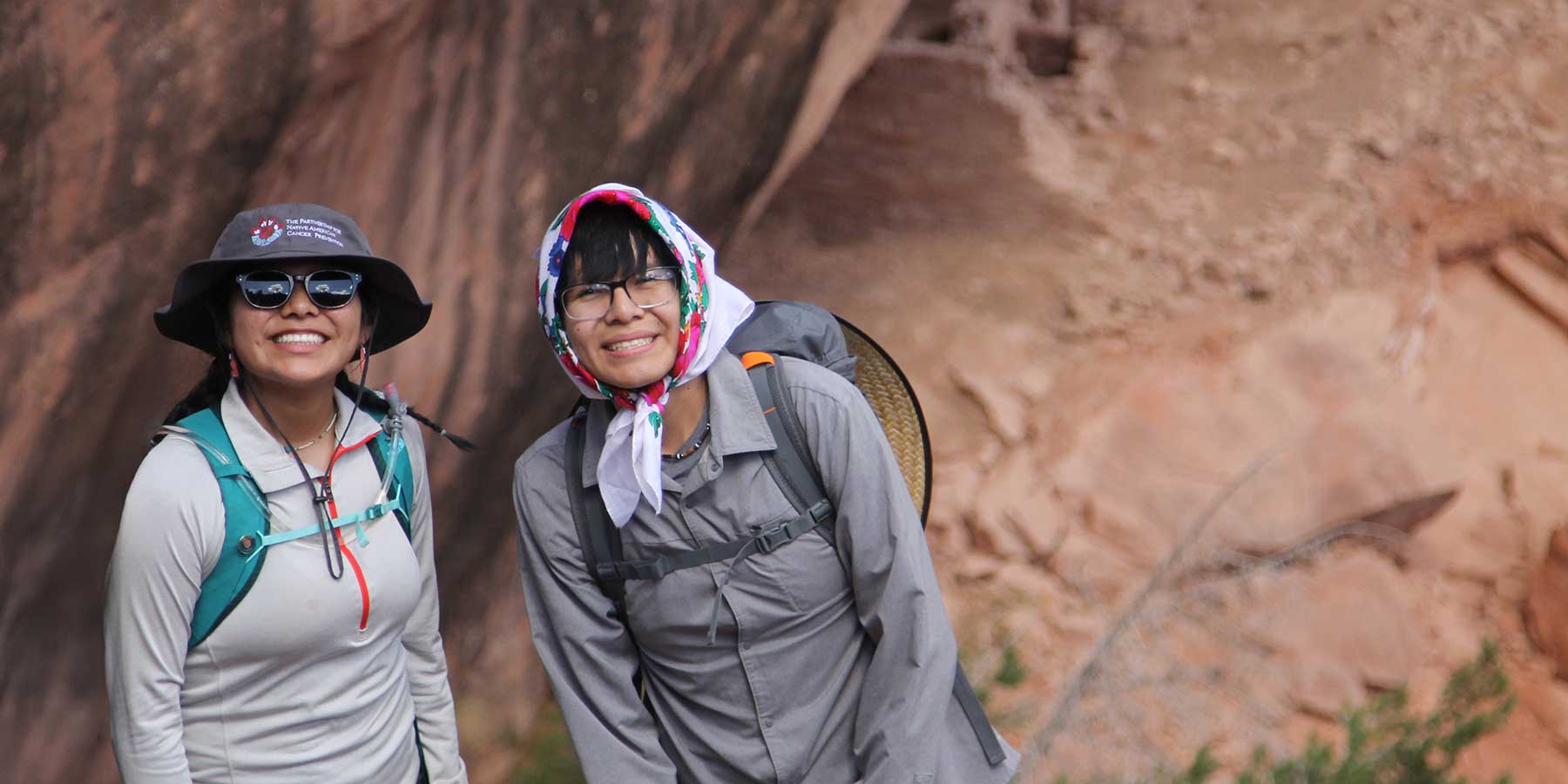 Two young rising leaders smile at the camera while learning about environmental justice advocacy on the Colorado Plateau