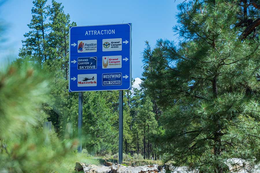 A road sign in Tusayan, AZ listing out gas stations, restaurants, and other nearby attractions