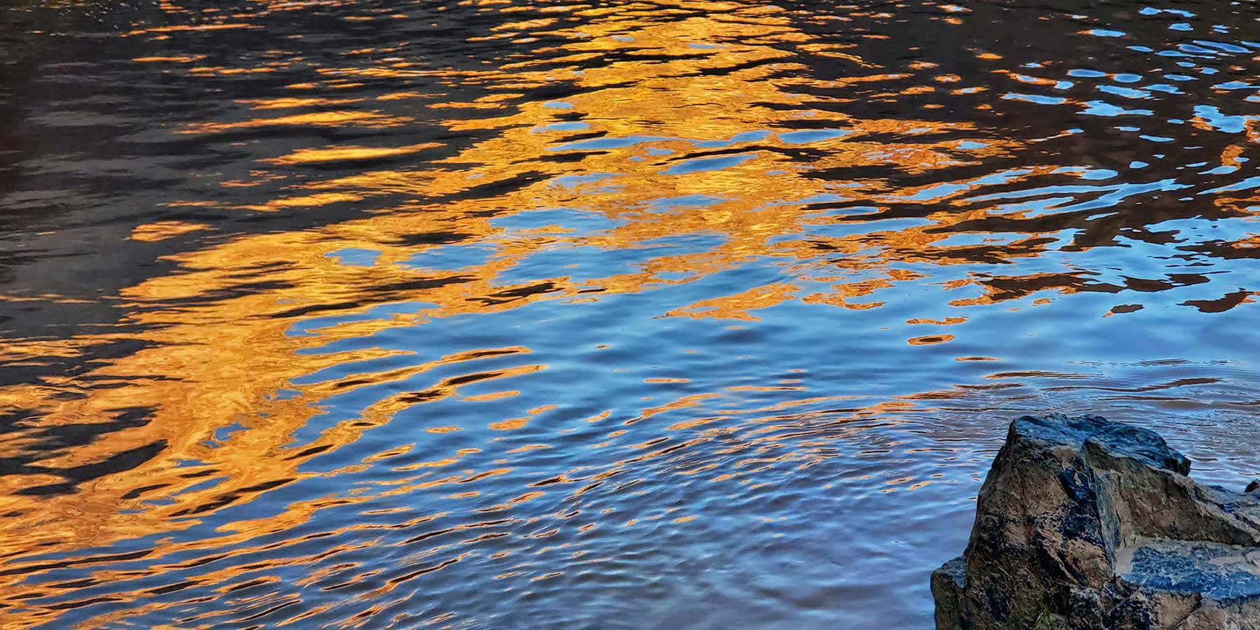 Light reflects off dark ripples in the Colorado River